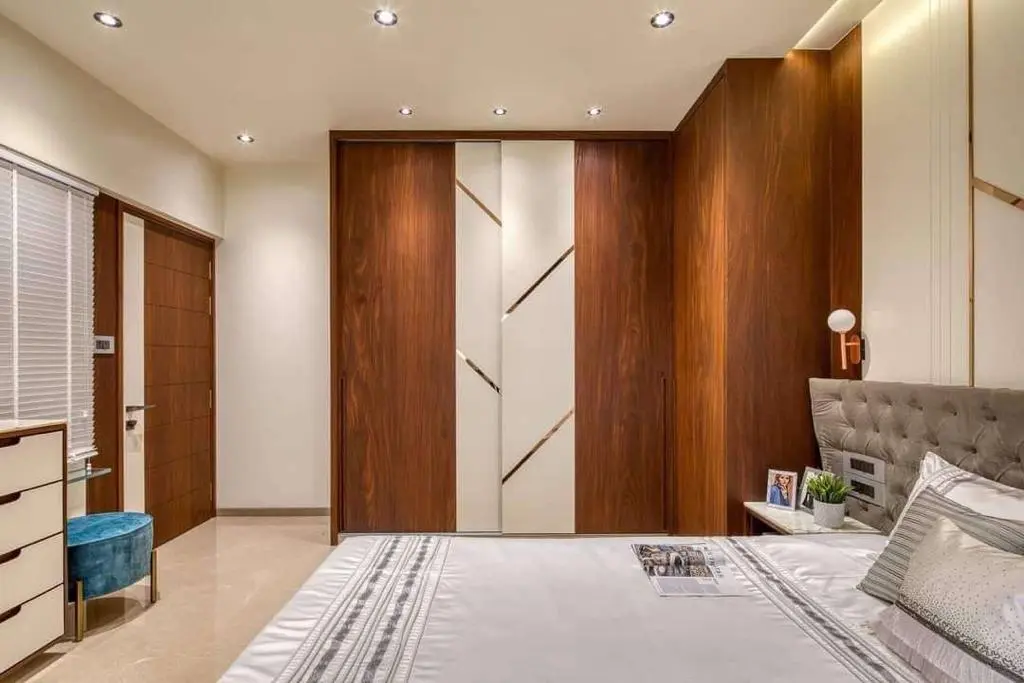 A bedroom with a large bed, dresser and closet